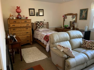 Cozy resident room with a bed and sitting area