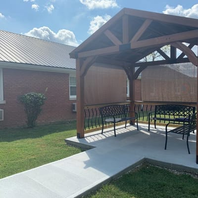 Outdoor sitting area with shaded gazebo and benches