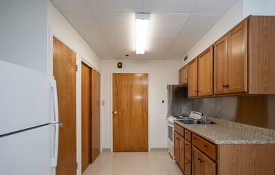 Bright, clean kitchen area with wooden cabinets