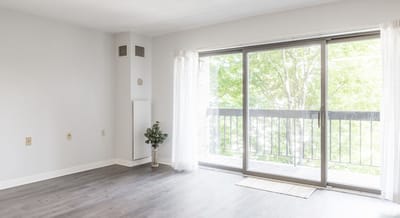 Bright interior space with sliding glass doors and view of trees