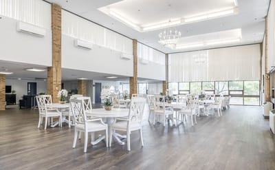 Bright and spacious common area with dining tables