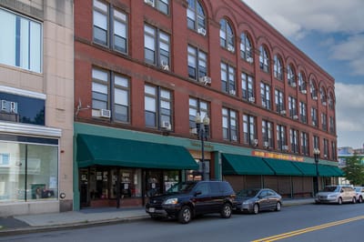 Exterior view of Fabens Building with parked vehicles