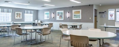 Bright common area with table seating for activities