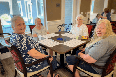 Residents enjoying a bingo game in the common area
