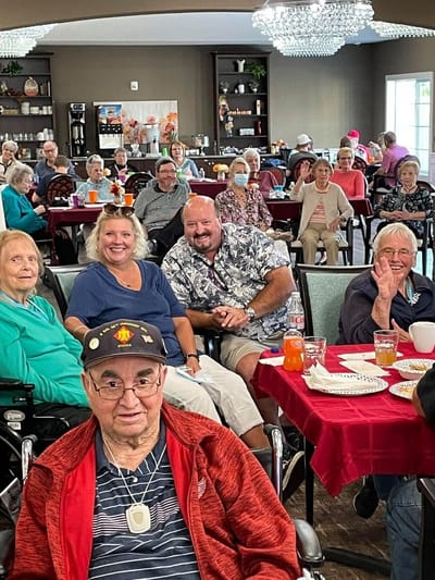 Residents and staff in a dining room during an event