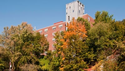 Exterior view of Fairweather Apartments amid autumn foliage