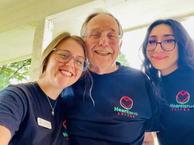 Three people smiling in a shared joyful moment