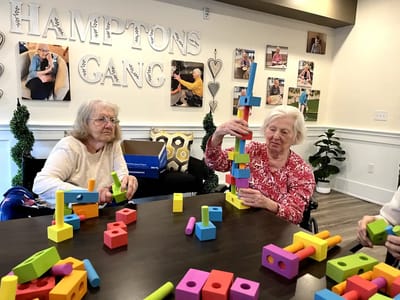 Residents engaging in a building activity with colorful blocks