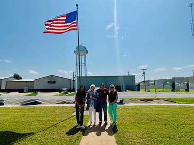 Group of people outdoors with an American flag