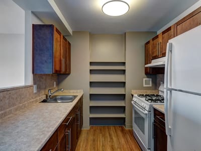 Modern kitchen area with wooden cabinets and appliances