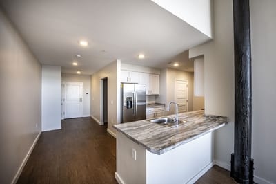 A clean, modern kitchen and living space in a resident's apartment