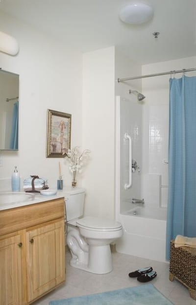 Well-lit bathroom with blue accents
