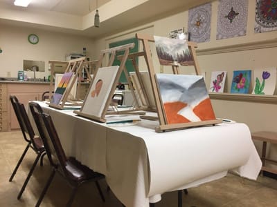 Art supplies and easels set up for a painting activity