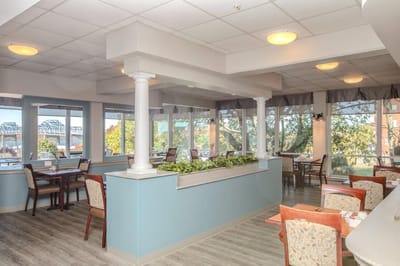 Bright dining room with large windows and tables