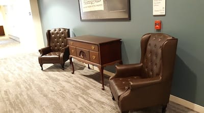 Interior view of two leather chairs in a hallway