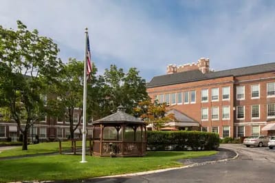 Exterior view of a senior living facility with gazebo