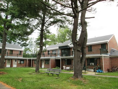 Exterior view of a senior living facility surrounded by trees