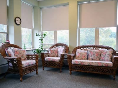 Cozy seating area with floral sofas and natural light
