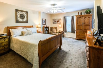 Cozy resident bedroom with wooden furniture and decor