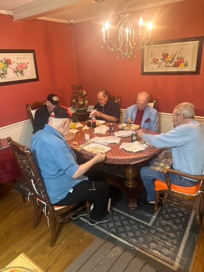 Residents enjoying a meal together at a dining table