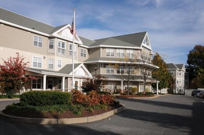 Exterior view of a senior living facility with landscaping