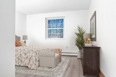 A well-decorated private resident room with a floral bedspread