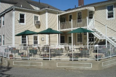 Exterior view of a senior living facility with outdoor seating