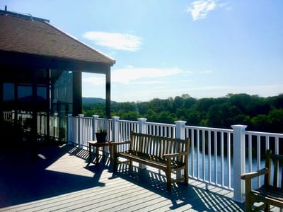 Outdoor deck overlooking a river and trees