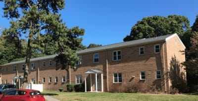 View of a multi-story building surrounded by trees