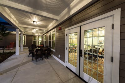 Outdoor patio area leading to a dining room
