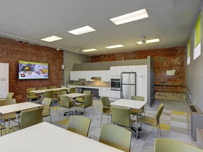 Bright dining area with modern furniture and kitchen appliances