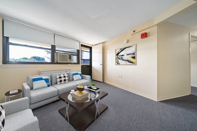 Bright interior of a resident room with seating area