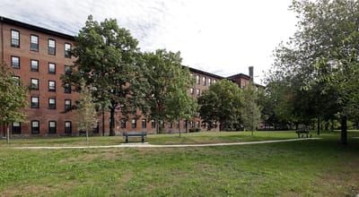 Exterior view of assisted living facility with gardens