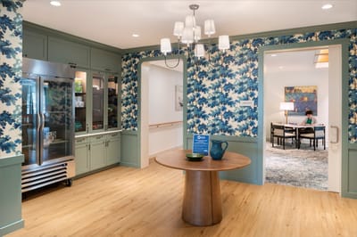 Bright common area with floral decor and residents