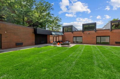 Outdoor area of Village At Brookline with green lawn and seating