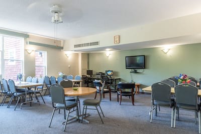 Bright common area with tables and chairs set up