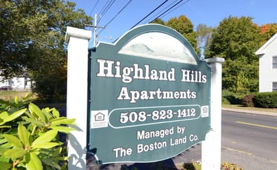 Signage for Highland Hills Apartments with contact information