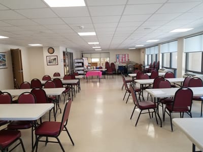 Bright common area with tables and chairs set up