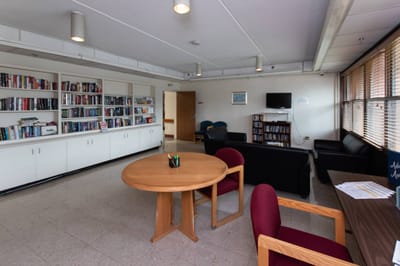 Bright common area with bookshelves and seating