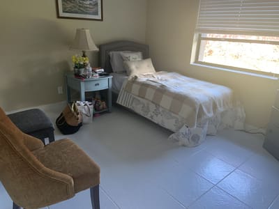 Private resident room with bed and decorative lamp