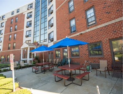 Outdoor seating area with tables and umbrellas