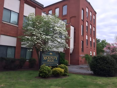 Exterior view of McKinley House with sign and greenery