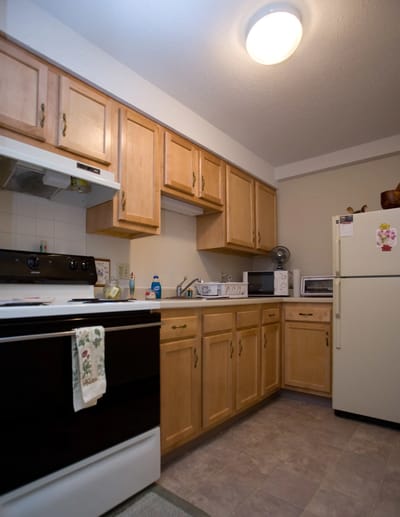 Bright kitchen area with light wood cabinets