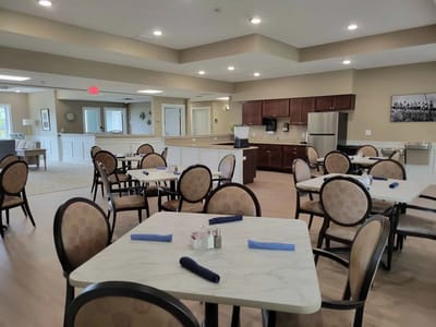 Bright dining area with tables and chairs set up