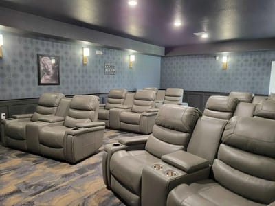 Interior view of a cinema room with reclining chairs