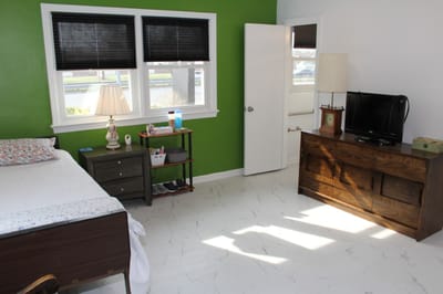 Interior view of a resident room with bed and furniture