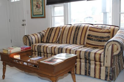 Cozy living room with a striped sofa and coffee table
