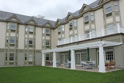 Exterior view of the assisted living facility with outdoor seating