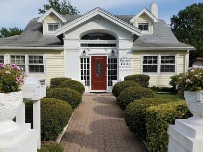 Exterior view of Forest Hills Guest Home with landscaped grounds