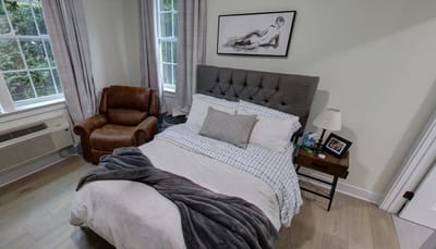 Cozy resident room with a bed and chair